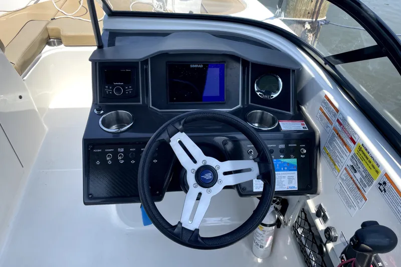 Slide: The Image of 2025 Bayliner VR6 Bowrider OB dashboard with steering wheel, controls, and navigation display. - 7