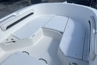 Slide: The Image of 2023 Trophy T22 boat interior with white seating and storage compartments. - 10