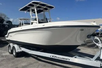 Slide: The Image of 2023 Trophy T22 boat on trailer under clear blue sky. - 2