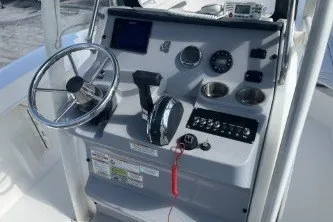 Slide: The Image of 2023 Trophy T22 boat dashboard with steering wheel and control panel. - 9