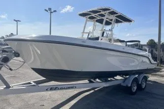 Slide: The Image of 2023 Trophy T22 boat on trailer, sleek design, parked outdoors under clear sky. - 4