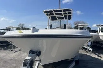 Slide: The Image of 2023 Trophy T22 boat with T-top, parked outdoors under a clear blue sky. - 3