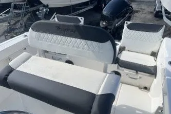 Slide: The Image of 2023 Trophy T22 boat interior with cushioned seating and storage compartments. - 12