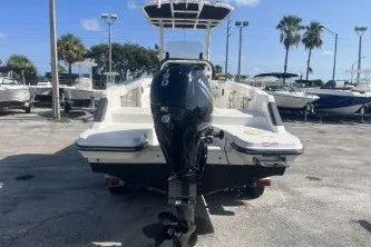 Slide: The Image of 2023 Trophy T22 boat with outboard motor, parked in a marina under clear blue skies. - 6