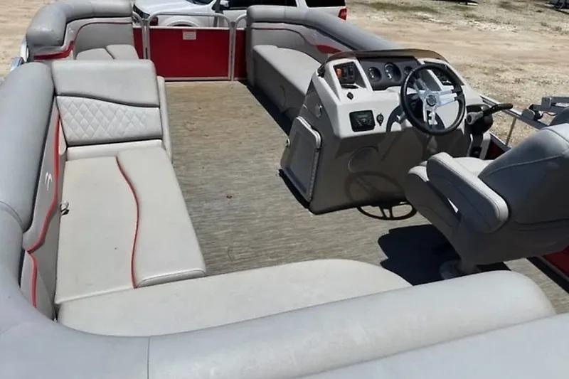 Slide: The Image of 2021 Bennington 205E pontoon boat interior with gray seating and steering console. - 2