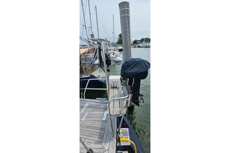 Slide: The Image of Docked 1999 Farr Pilothouse 50 sailboat with covered outboard motor. - 30