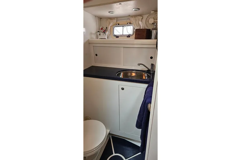 Slide: The Image of Bathroom interior of 1999 Farr Pilothouse 50 yacht with sink and toilet. - 13