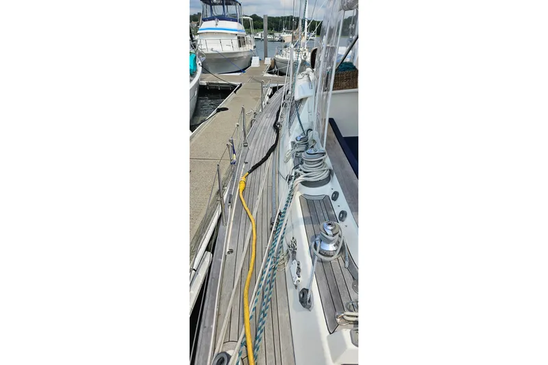 Slide: The Image of 1999 Farr Pilothouse 50 sailboat docked, showcasing deck and rigging details. - 23