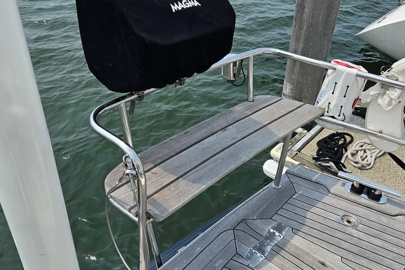 Slide: The Image of Deck of a 1999 Farr Pilothouse 50 yacht with railing and docked ropes. - 29