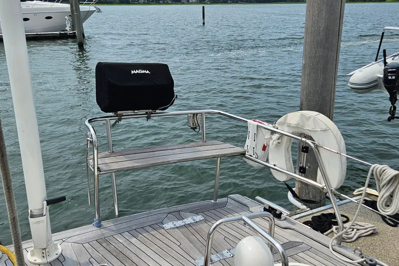 Slide: The Image of Stern view of 1999 Farr Pilothouse 50 yacht with Magma grill and life preserver. - 28