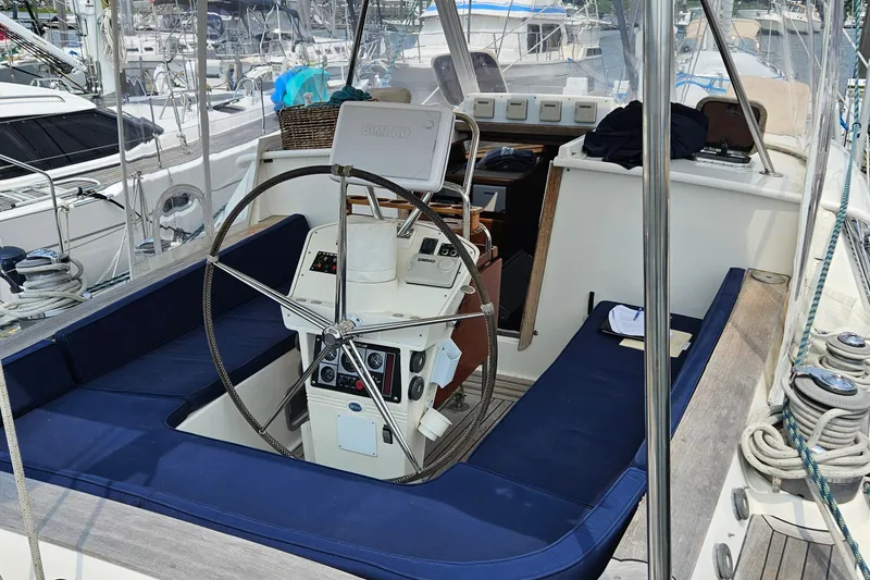 Slide: The Image of Cockpit of 1999 Farr Pilothouse 50 sailboat with steering wheel and navigation equipment. - 15