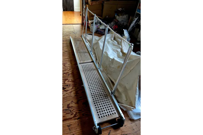 Slide: The Image of Gangway for 1999 Farr Pilothouse 50, resting on wooden floor indoors. - 32