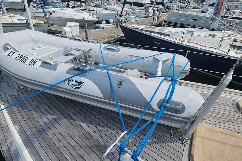 Slide: The Image of Inflatable dinghy secured on Farr Pilothouse 50 yacht deck, marina background, 1999 model. - 31
