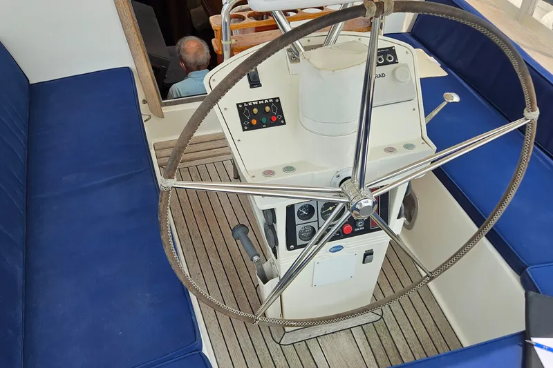 Slide: The Image of Cockpit of 1999 Farr Pilothouse 50 sailboat with steering wheel and navigation controls. - 16