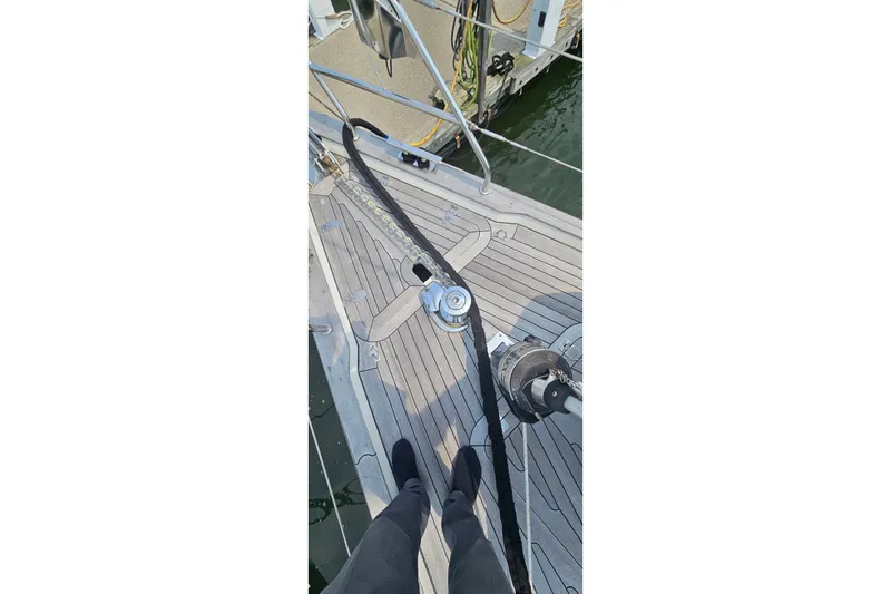 Slide: The Image of Deck view of a 1999 Farr Pilothouse 50 sailboat, featuring winch and mooring line. - 22