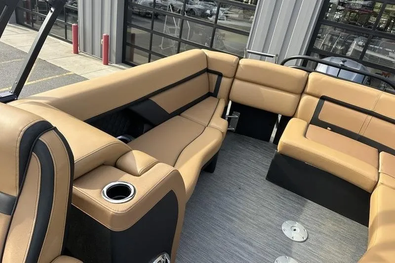 Slide: The Image of Luxurious seating on 2024 AquaPatio 235 UL boat with tan upholstery and cup holders. - 20