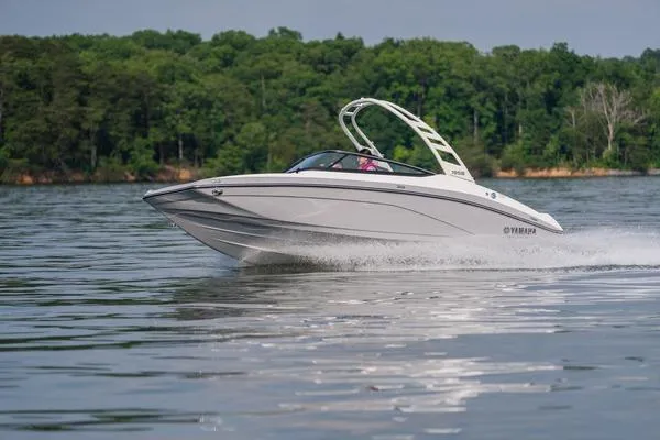 Slide: The Image of 2026 Yamaha Boats 195S cruising on a serene lake with lush green forest backdrop. - 2