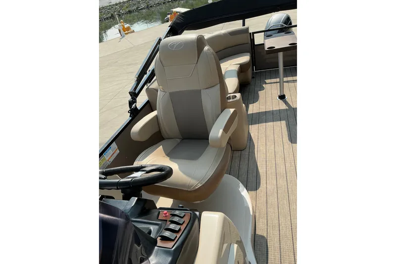 Slide: The Image of 2022 Veranda Relax VR22RC boat interior with beige seating and steering console. - 20
