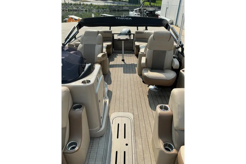 Slide: The Image of 2022 Veranda Relax VR22RC pontoon boat interior with beige seating and cup holders. - 17
