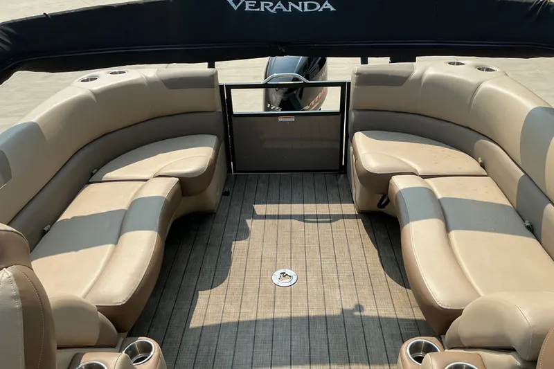 Slide: The Image of Interior of 2022 Veranda Relax VR22RC pontoon boat with beige seating and cup holders. - 14