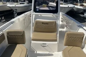 Slide: The Image of 2024 Trophy T24 CC boat interior with beige seating and console. - 11