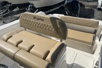 Slide: The Image of 2024 Trophy T24 CC boat seating with beige upholstery and diamond stitching. - 12