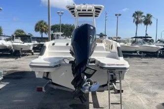 Slide: The Image of 2024 Trophy T24 CC boat with outboard motor in a sunny marina. - 6