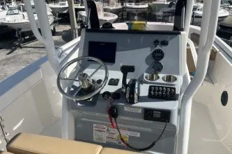 Slide: The Image of 2024 Trophy T24 CC boat console with steering wheel and navigation controls. - 9