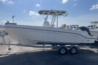 Slide: The Image of 2024 Trophy T24 CC boat on trailer under clear blue sky. - 5