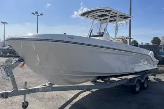Slide: The Image of 2024 Trophy T24 CC boat on trailer under clear sky. - 4