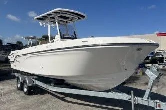 Slide: The Image of 2024 Trophy T24 CC boat on trailer under clear blue sky. - 2
