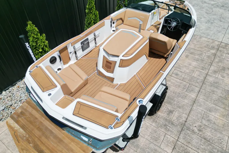 Slide: The Image of 2023 MasterCraft ProStar boat with tan interior and sleek design on a trailer. - 17