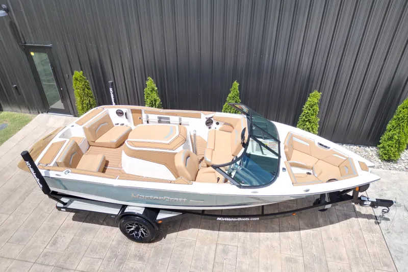 Slide: The Image of 2023 MasterCraft ProStar boat with tan interior, parked on a trailer. - 21