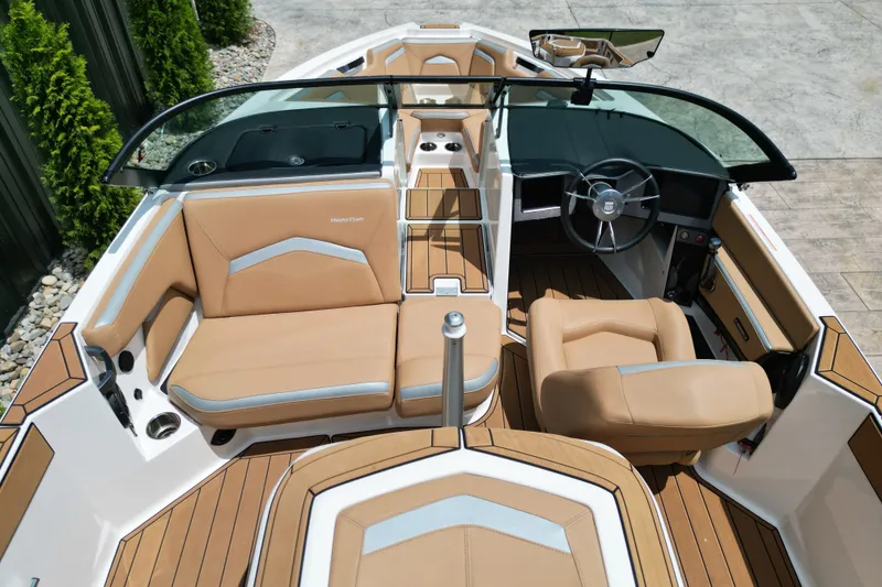 Slide: The Image of 2023 MasterCraft ProStar boat interior with tan seating and sleek dashboard design. - 15