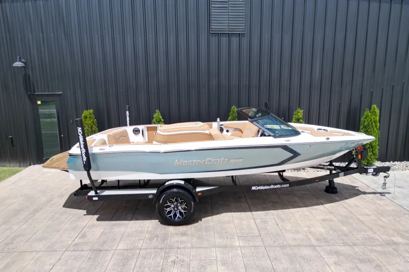 Slide: The Image of 2023 MasterCraft ProStar boat on trailer, parked outdoors. - 23