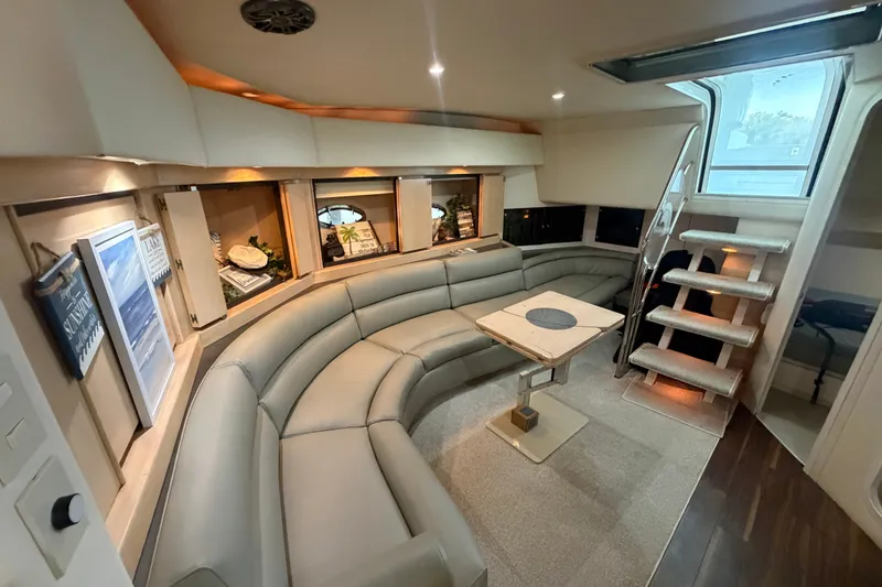 Slide: The Image of Luxurious interior of a 1997 Trojan 440 Express yacht with plush seating and modern decor. - 26