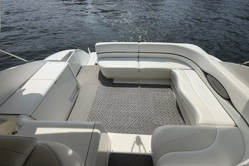 Slide: The Image of Spacious deck of 1997 Trojan 440 Express yacht with white seating and water view. - 11