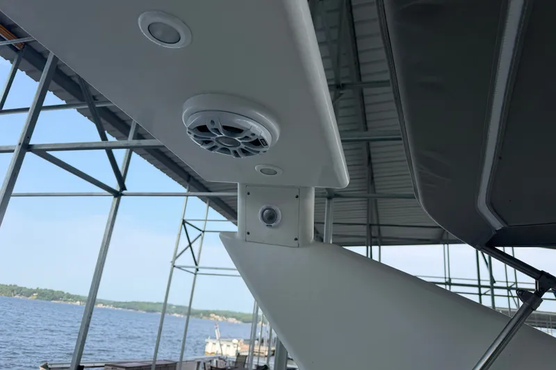 Slide: The Image of 1997 Trojan 440 Express boat with speaker and camera, docked by the water. - 22