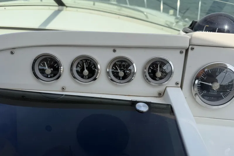 Slide: The Image of Dashboard of a 1997 Trojan 440 Express boat with various gauges and instruments. - 16