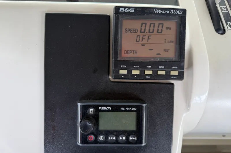 Slide: The Image of Control panel of a 1997 Trojan 440 Express boat with B&G and Fusion displays. - 40