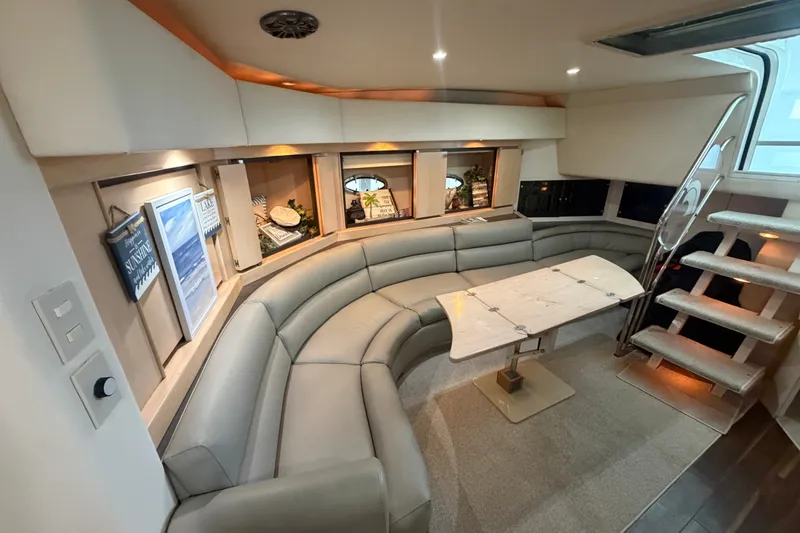 Slide: The Image of Luxurious interior of a 1997 Trojan 440 Express yacht with curved seating and elegant decor. - 25