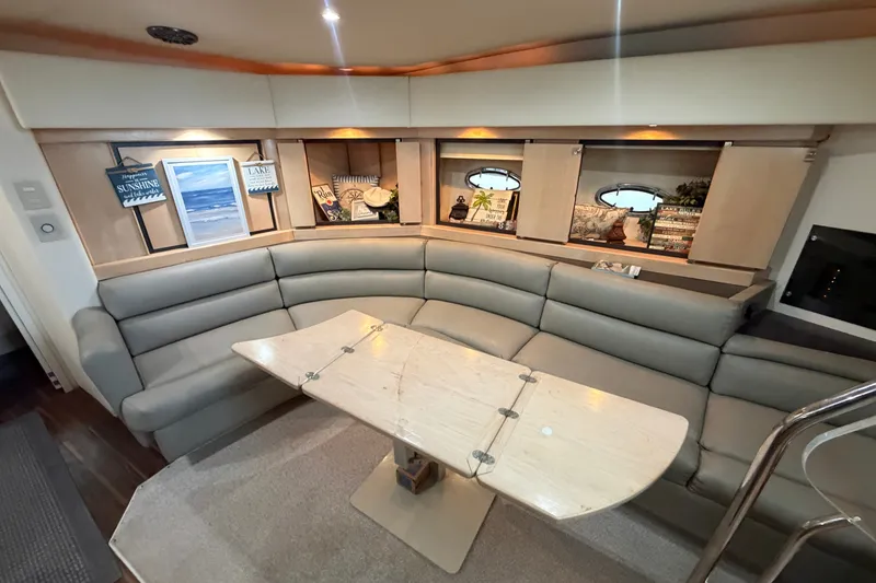 Slide: The Image of Luxurious interior of a 1997 Trojan 440 Express yacht with elegant seating and decor. - 24