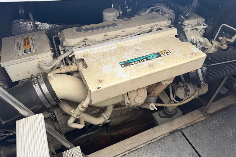 Slide: The Image of Engine compartment of a 1997 Trojan 440 Express boat, featuring a CAT marine engine. - 41