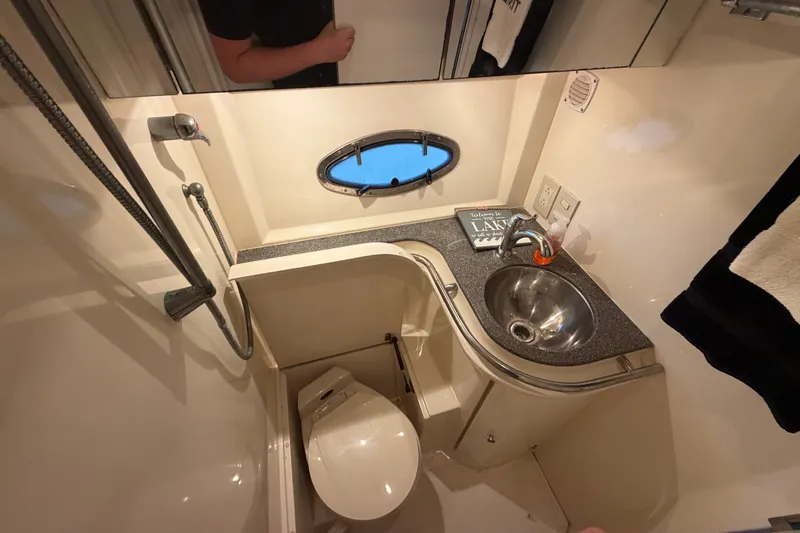 Slide: The Image of Bathroom interior of 1997 Trojan 440 Express yacht with sink, toilet, and shower. - 28