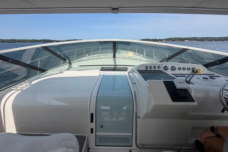Slide: The Image of Cockpit view of a 1997 Trojan 440 Express yacht on open water. - 9
