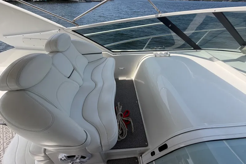 Slide: The Image of Luxury seating on a 1997 Trojan 440 Express yacht, overlooking serene waters. - 10