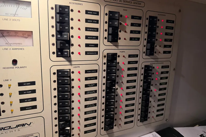 Slide: The Image of Control panel of a 1997 Trojan 440 Express yacht with switches and indicators. - 37