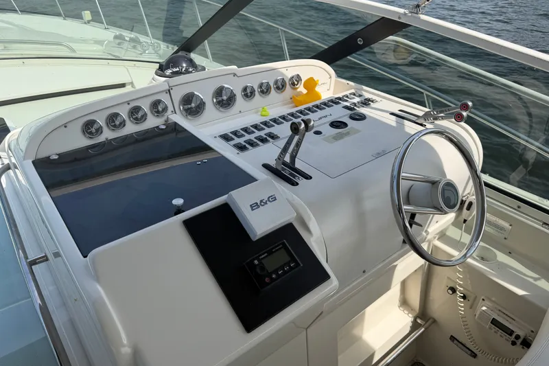 Slide: The Image of Cockpit of a 1997 Trojan 440 Express yacht with steering wheel and control panel. - 13