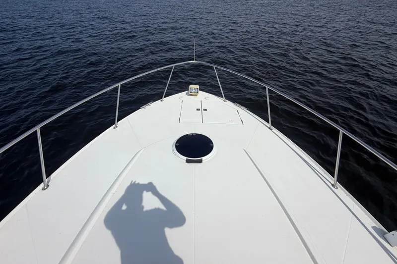 Slide: The Image of Bow view of 1997 Trojan 440 Express yacht on open water. - 6