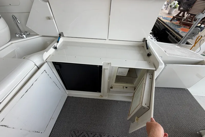Slide: The Image of Interior view of a 1997 Trojan 440 Express yacht with open storage compartments. - 20